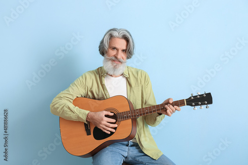 Bearded senior man playing ...