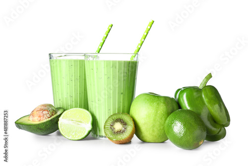 Glasses of healthy green juice and fresh ingredients on white background