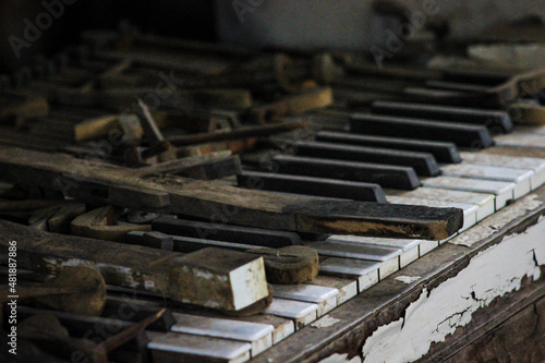 Old ruined piano in an abandoned house in the village shack close up of keys side angle