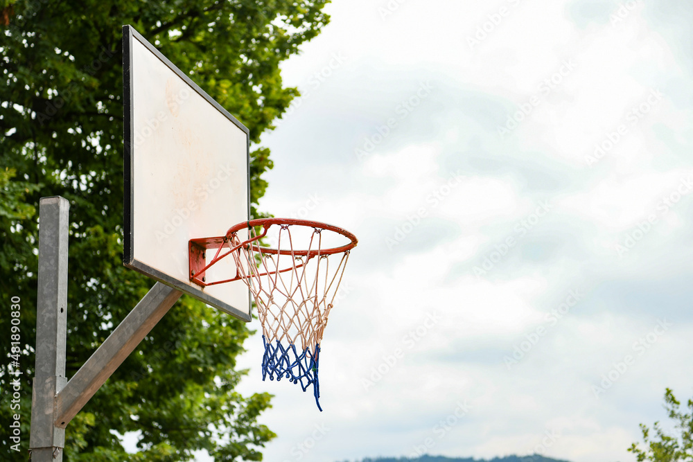 basketball hoop and net on the background of blue sky with negative space