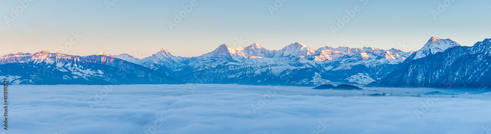 winter landscape with swiss mountains and fog