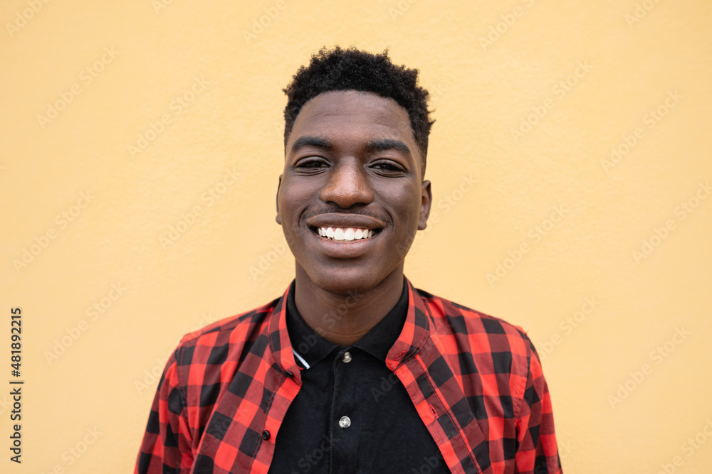 Obraz premium Portrait of happy young African teenager smiling in front of camera