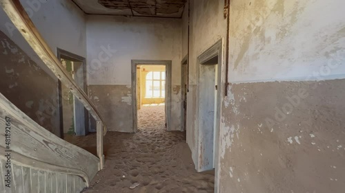 Abandoned building in ghost town Kolmanskop in desert. Room in house with sand.