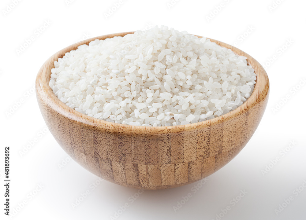 Uncooked round rice in wooden bowl isolated on white background with clipping path