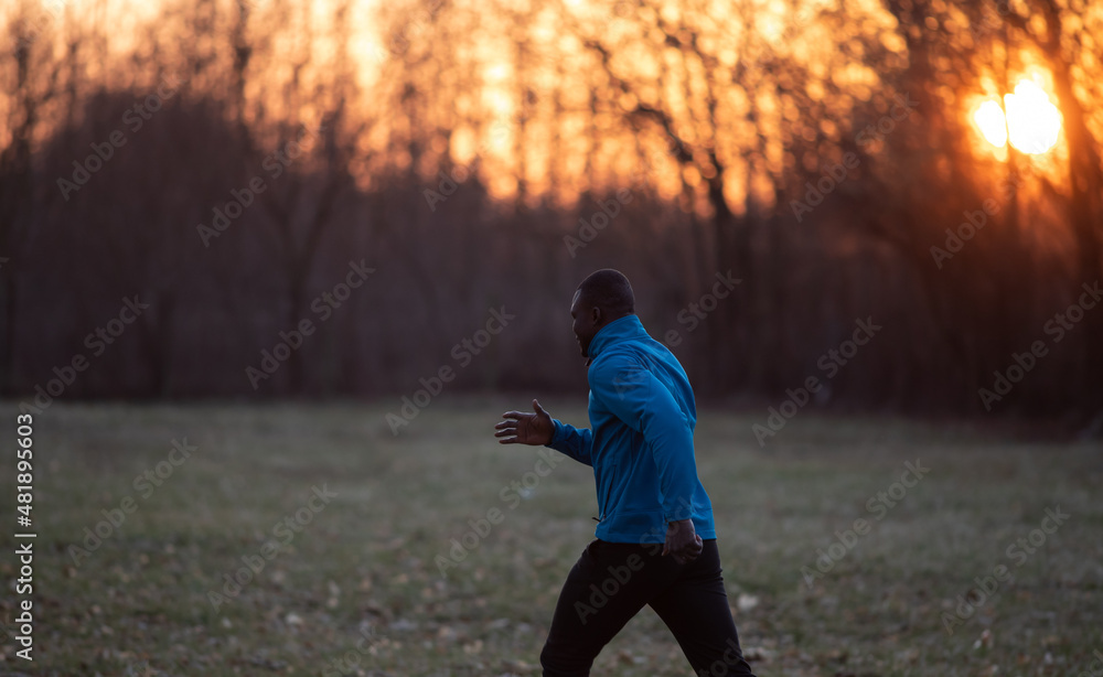 Fototapeta premium Black man jogging in nature in winter time