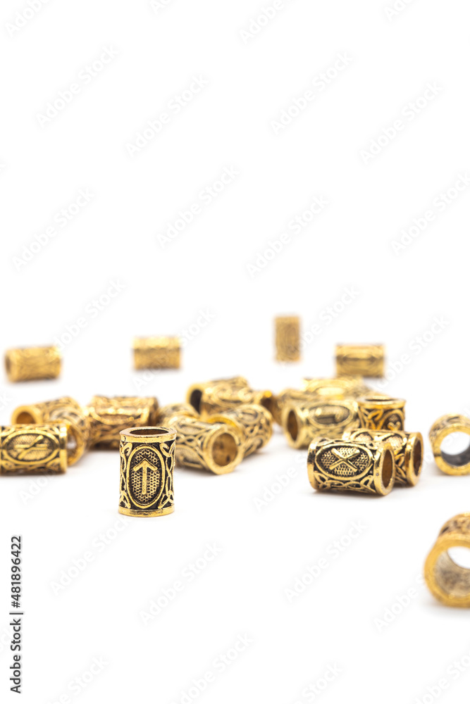 Isolated photos of metal beads with Scandinavian runes