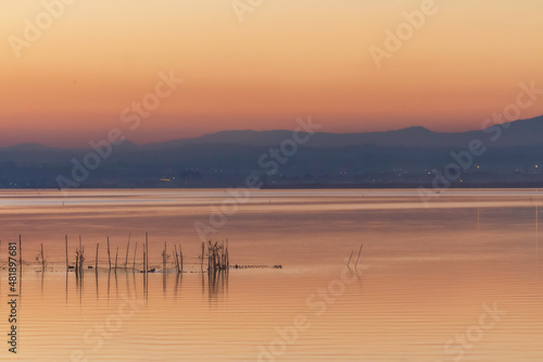 Sunset at the Albufera lake in Valencia with the fishermen s nets in the foreground.
