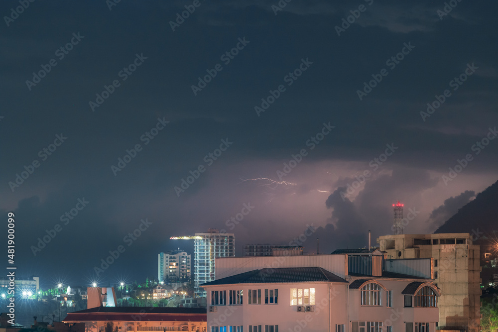 Fototapeta premium Night thunderstorm over the city in mountains
