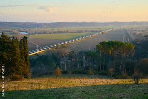 Sunset in the countryside of Rome with a view on the E35 motorway photo