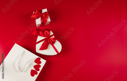 Flat lay. Packaging for purchases, gifts and parcels on a red background. The concept of delivery of gifts and parcels for the holidays valentines day, pleasant surprises. Shopping, sale, promotion.