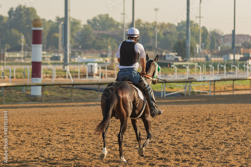 race horse exercise rider and horse during morning workout 