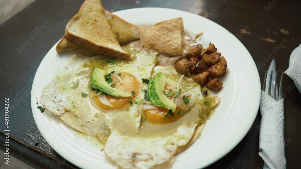 breakfast fried egg, avocado, toast bread and potato on the table. food footage. High quality 4k footage breakfast fried egg, avocado, toast bread and potato on the table. food footage. High quality 4k footage
