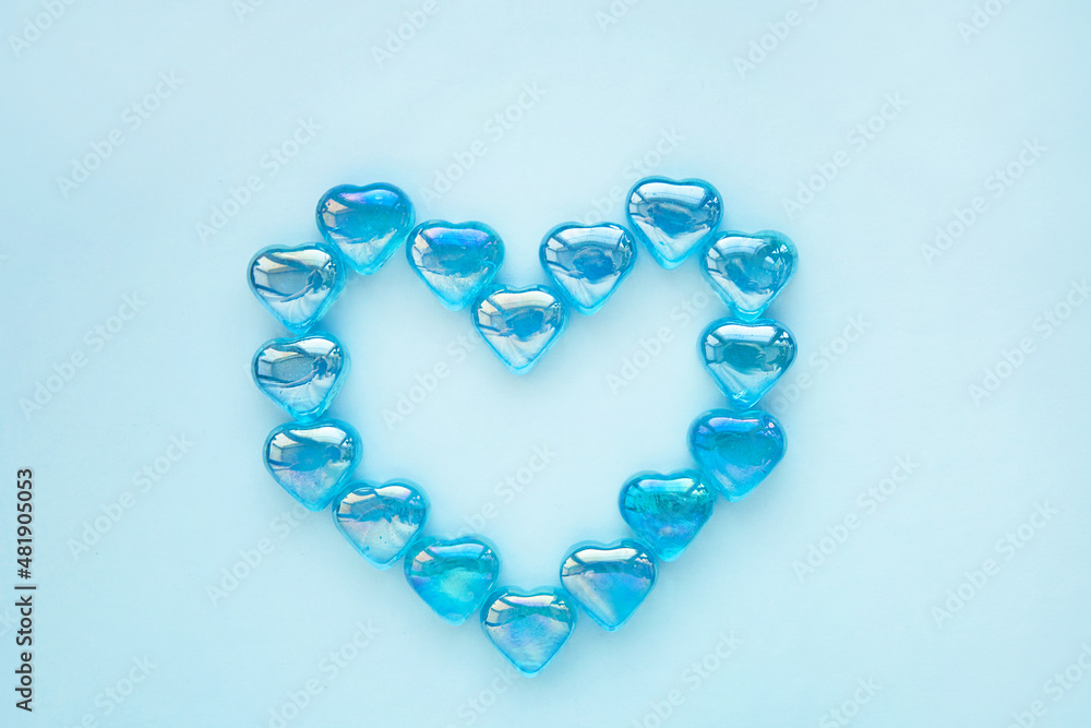 Glass hearts on a blue background. Valentine's day greeting, wedding and invitation concept. Glass hearts on a blue background. Valentine's day greeting, wedding and invitation concept.