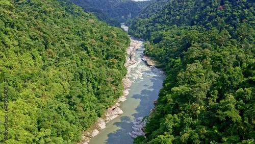 Aerial view of a stunning mountain river with a granite rockbed surrounded by hills covered in tropical forest: a relaxing nature background from Ecuador, South america photo