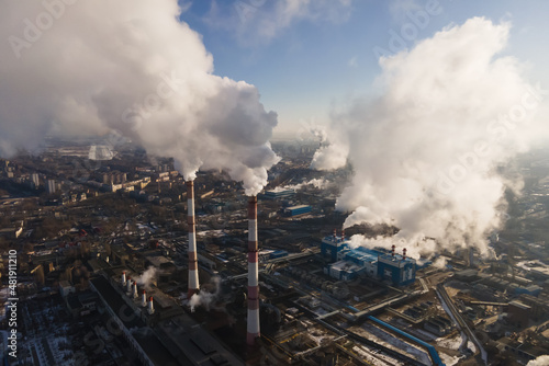 Factory smokestack emissions, climate change and global warming for the environment concept. Aerial view