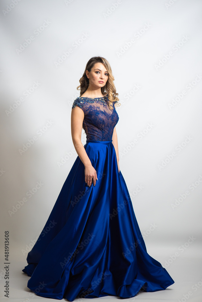 beautiful young blond woman in dress on white studio background beautiful young blond woman in dress on white studio background
