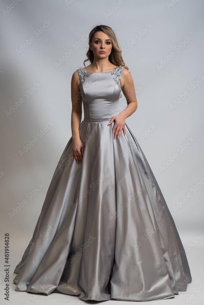 beautiful young blond woman in dress on white studio background beautiful young blond woman in dress on white studio background