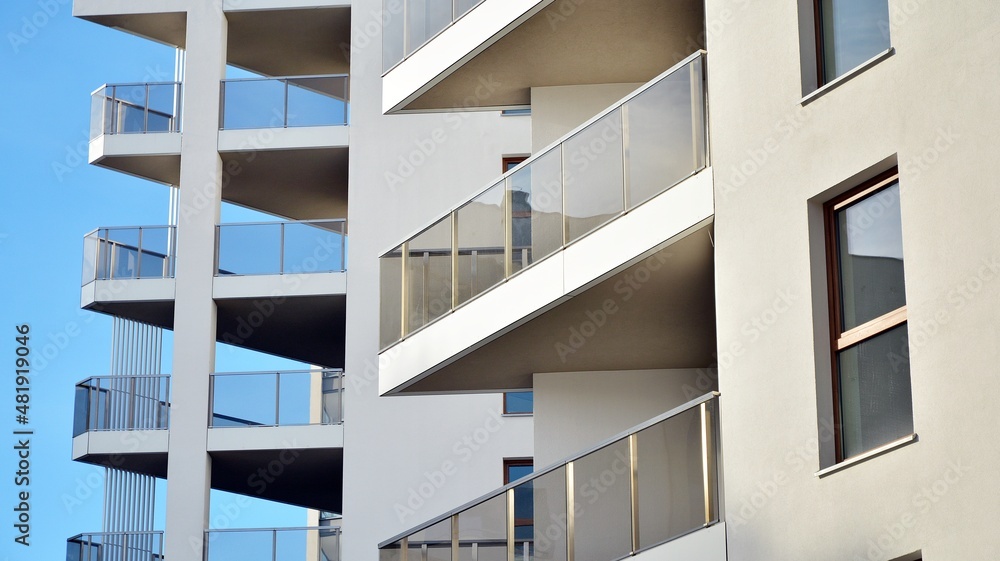 Modern luxury residential flat. Modern apartment building on a sunny day. White apartment building with a blue sky. Facade of a modern apartment building. - obrazy, fototapety, plakaty 
