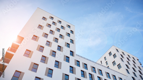 Modern luxury residential flat. Modern apartment building on a sunny day. White apartment building with a blue sky. Facade of a modern apartment building. photo