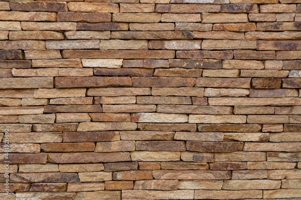Stone masonry of flat brown stone. Background, texture Stone masonry of flat brown stone. Background, texture