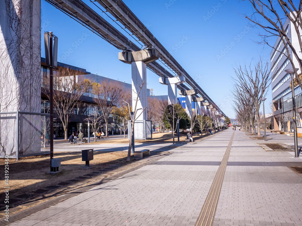 long straight pavement street and railway of monorail overhead a long the street in tokyo