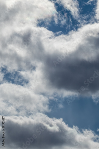 Fototapeta Naklejka Na Ścianę i Meble -  Dramatic sky clouds view texture background. Sunset high scenic layered cloudy blue heaven view. Vertical