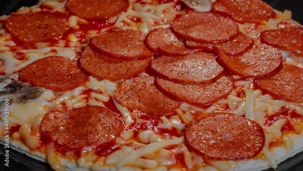 Timelapse - close up: pizza with pepperoni, cheese, sause baking on tray in electric oven in kitchen at home. Italian cuisine, homemade bakery, fast food, cooking and time lapse concept Timelapse - close up: pizza with pepperoni, cheese, sause baking on tray in electric oven in kitchen at home. Italian cuisine, homemade bakery, fast food, cooking and time lapse concept