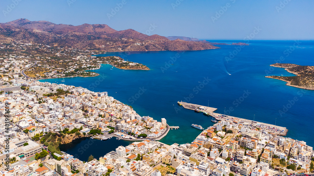 the town of Agios Nicholas on the island of Crete in Greece, in the frame is a bay, a tourist ship and the streets of the city