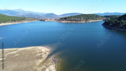 Nice aerial view slowly rising over the Jarosa reservoir in the mountain range of Madrid, located in a beautiful natural environment of the Sierra de Guadarrama, travel, concepts, 4k resolution
