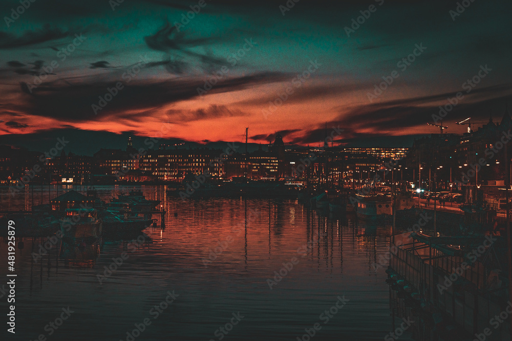 Picturesque Orange and Blue Sunset over Harbour with Boats and Twinkling City Lights