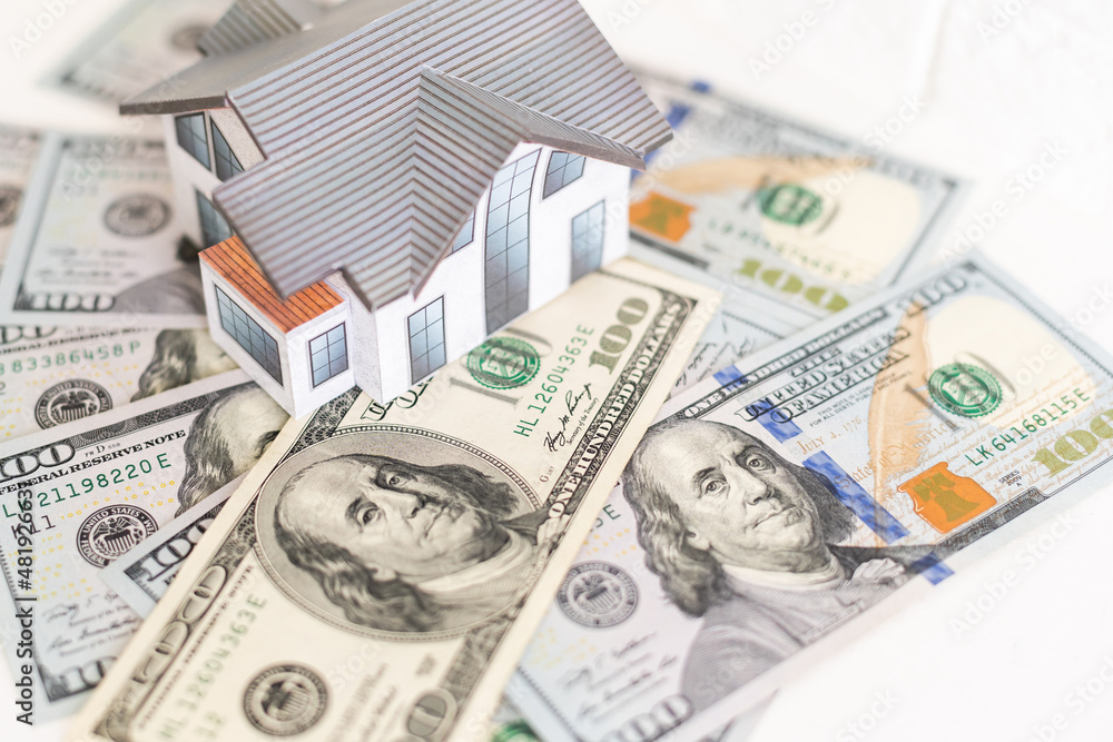 house layout and dollar bills on the background house layout and dollar bills on the background