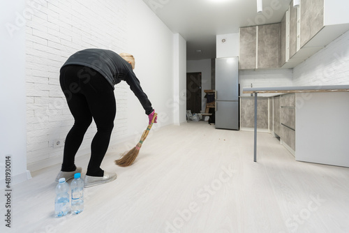 Cleaning lady in room after renovation
