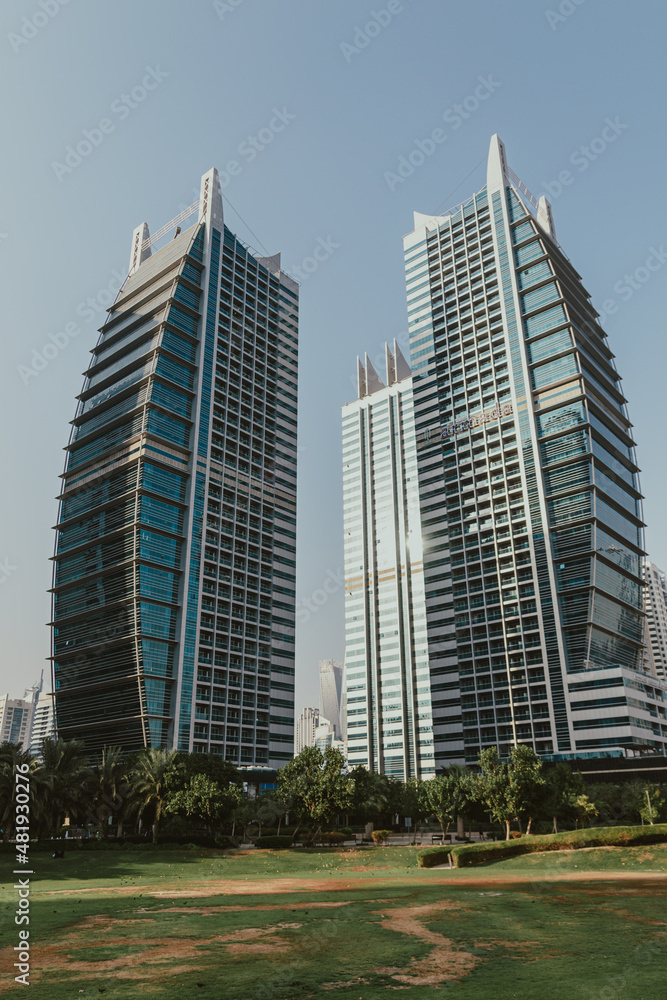 Public park area landscape with futuristic modern skyscrapers view 