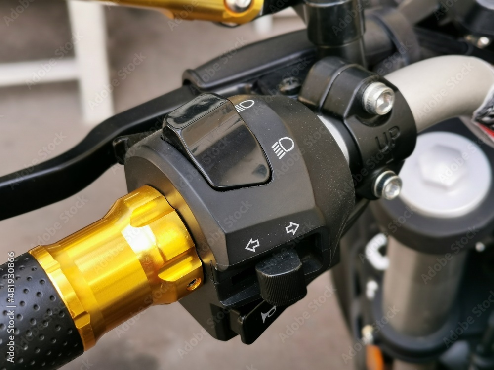 Close up image of motorcycle headlight, turn signal and horn buttons. Close up image of motorcycle headlight, turn signal and horn buttons.