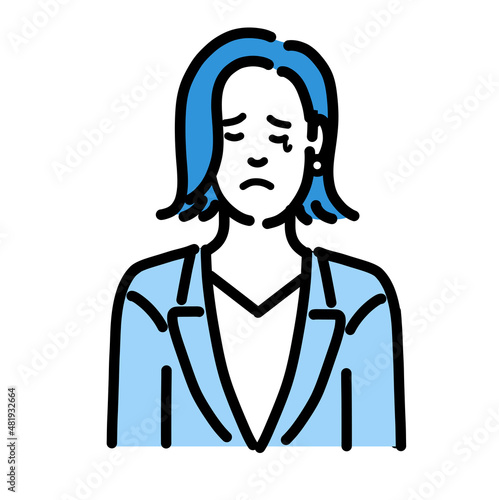悲しそうに涙を流しているスーツを着た若い女性
