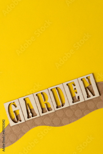 sign with the word  garden  in wooden stencil type on paper 