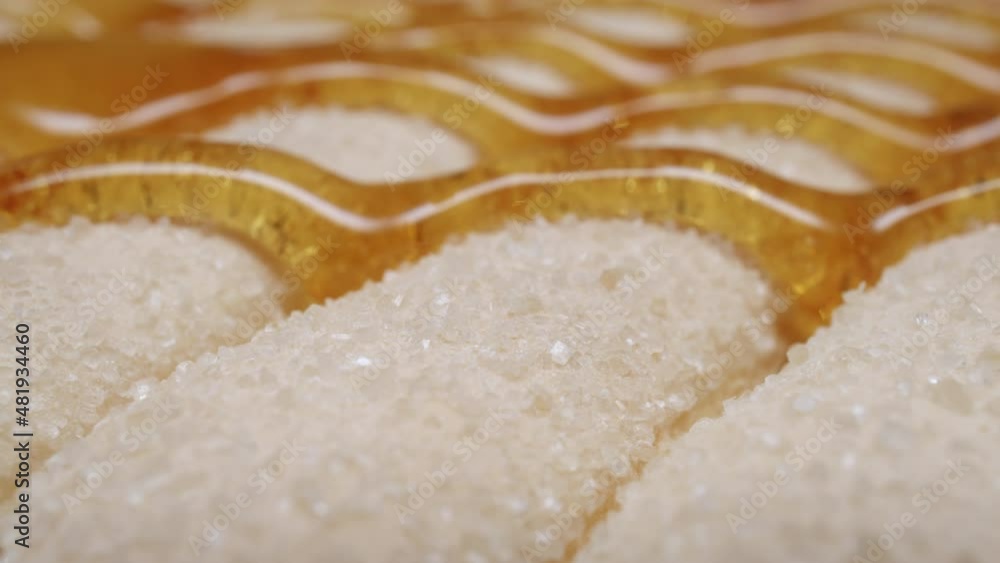 Seamless dripping caramel drops sweet sauce or honey flows over biscuits flour pastries cookies. Close-up macro shot flowing melted yellow orange tasty syrup drip. Confectionery, cooking dessert Seamless dripping caramel drops sweet sauce or honey flows over biscuits flour pastries cookies. Close-up macro shot flowing melted yellow orange tasty syrup drip. Confectionery, cooking dessert