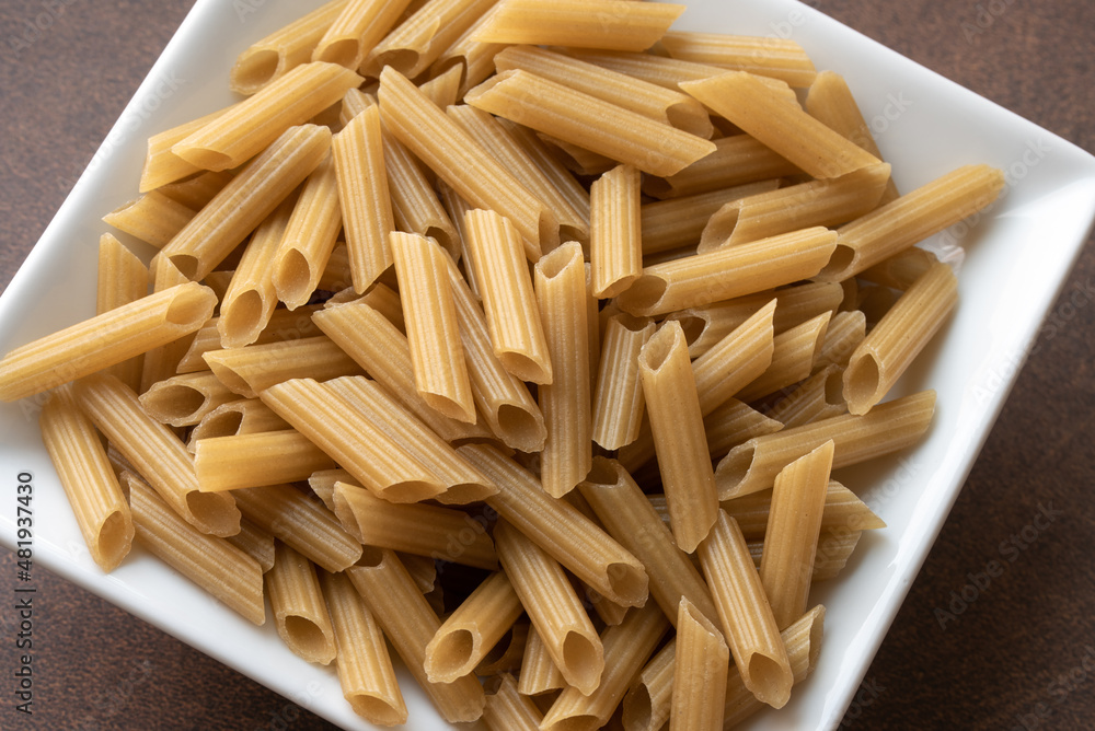 Uncooked Penne Pasta in a Bowl Uncooked Penne Pasta in a Bowl