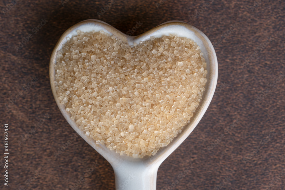 Cane Sugar on a Heart Shaped Spoon Cane Sugar on a Heart Shaped Spoon
