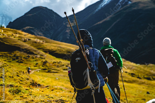 Adventure seekers hiking in the mountains with their trekking polls photo