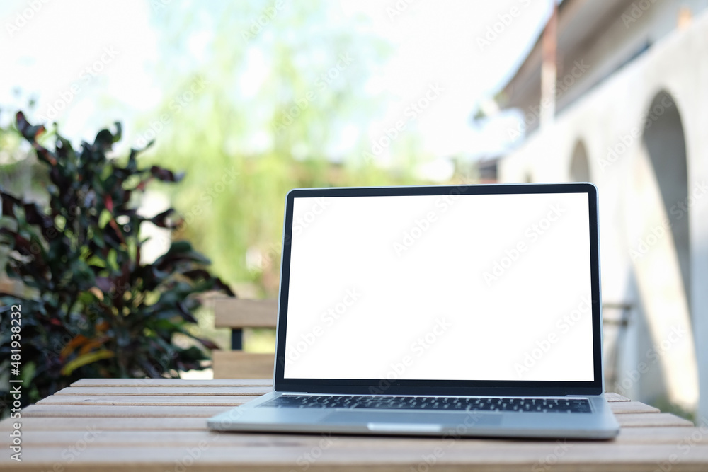 Mockup laptop computer with empty screen on wooden table at outdoor. Blank screen for your advertising text. Mockup laptop computer with empty screen on wooden table at outdoor. Blank screen for your advertising text.