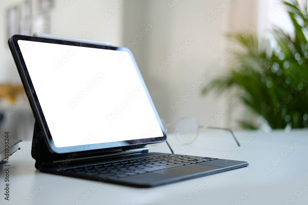 Mockup digital tablet with wireless keyboard on white table. Blank screen for your advertising text. Mockup digital tablet with wireless keyboard on white table. Blank screen for your advertising text.