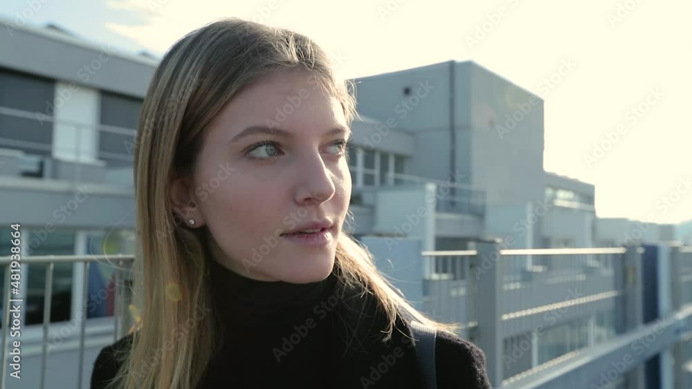 Girl in urban environment looks at the camera and walks away. Girl in urban environment looks at the camera and walks away.