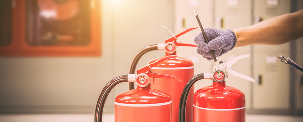 Fire extinguisher, Engineer inspection checking pressure gauge level fire extinguisher tank for protection and prevent emergency and safety rescue and fire alarm system training.