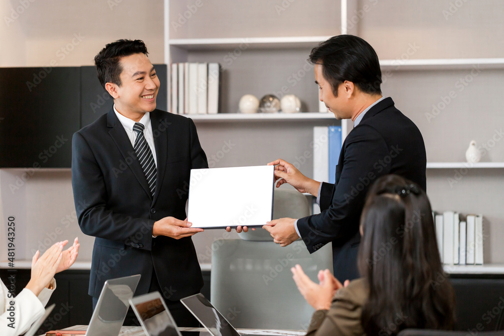 Employee gets a certificate of achievement, Businesspeople with certificate in the office, Businessman giving appreciation certificate to employee for achievement Employee gets a certificate of achievement, Businesspeople with certificate in the office, Businessman giving appreciation certificate to employee for achievement