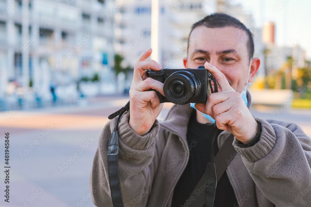 Man having fun taking pictures with a professional reflex camera. Man having fun taking pictures with a professional reflex camera.
