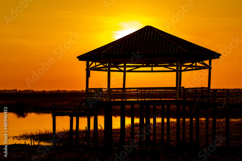 Dry or arid lake and old vintage pavilion with sunset light on the evening. © Phongsak