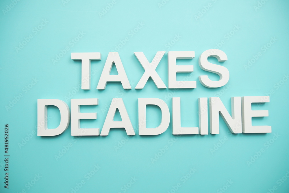 Taxes Deadline alphabet letters on blue background Taxes Deadline alphabet letters on blue background