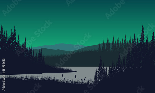 Mountain panorama with forest and lake silhouette from the out of the city at dusk