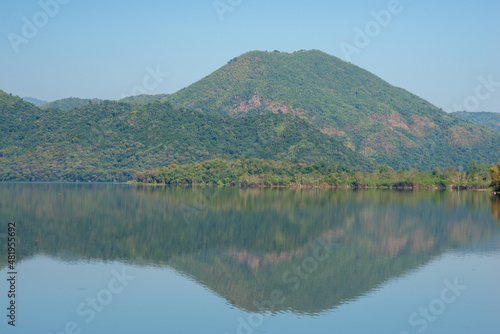 reflection of mountain pine forest and clear blue sky © Arthiti